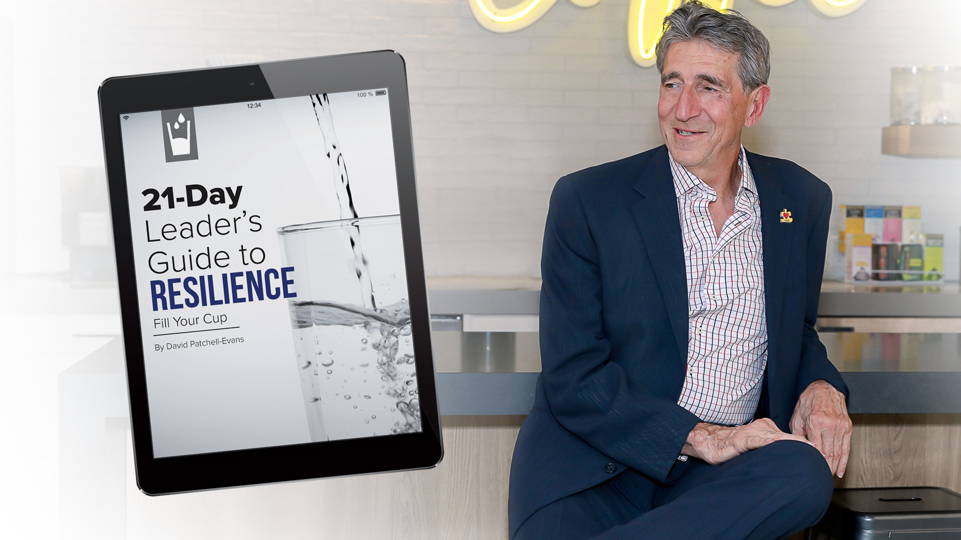 David Patchell Evans sitting gracefully next to a tablet that says 21-Day Leader's Guide to Resilience