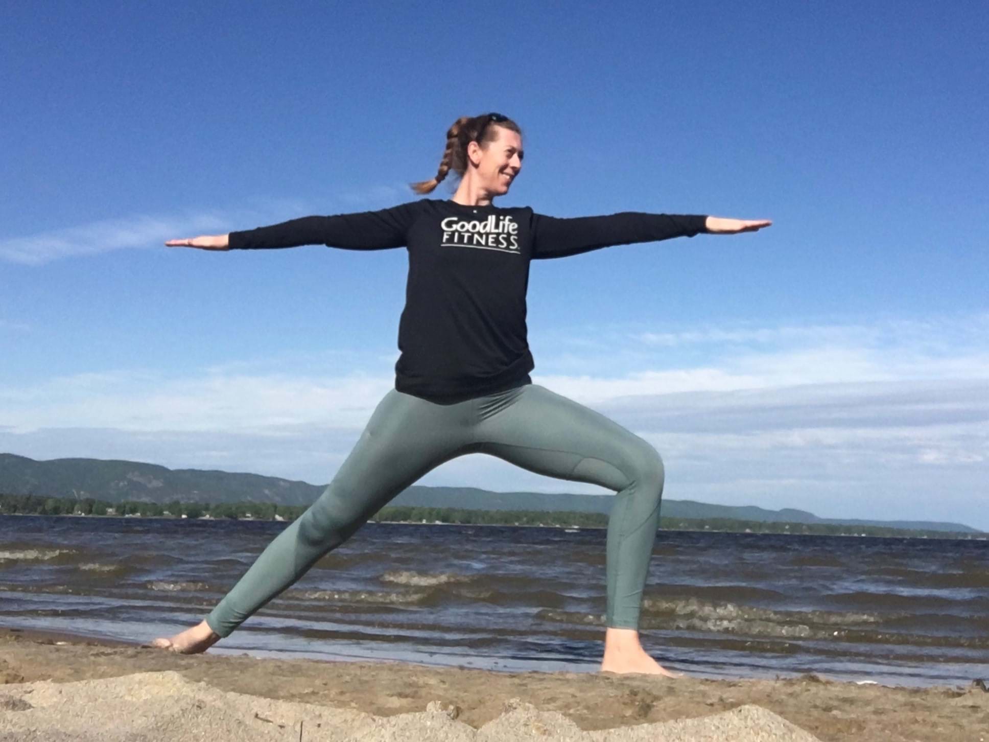Abby Johnson-Bertran practices yoga poses on the beach near Ottawa